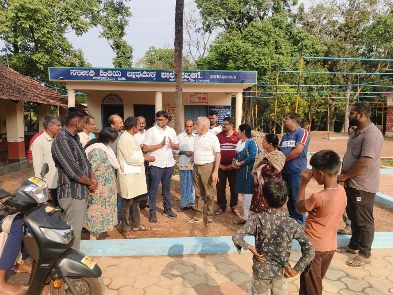 Community meeting outside a rural school ahead of a heart-health camp
