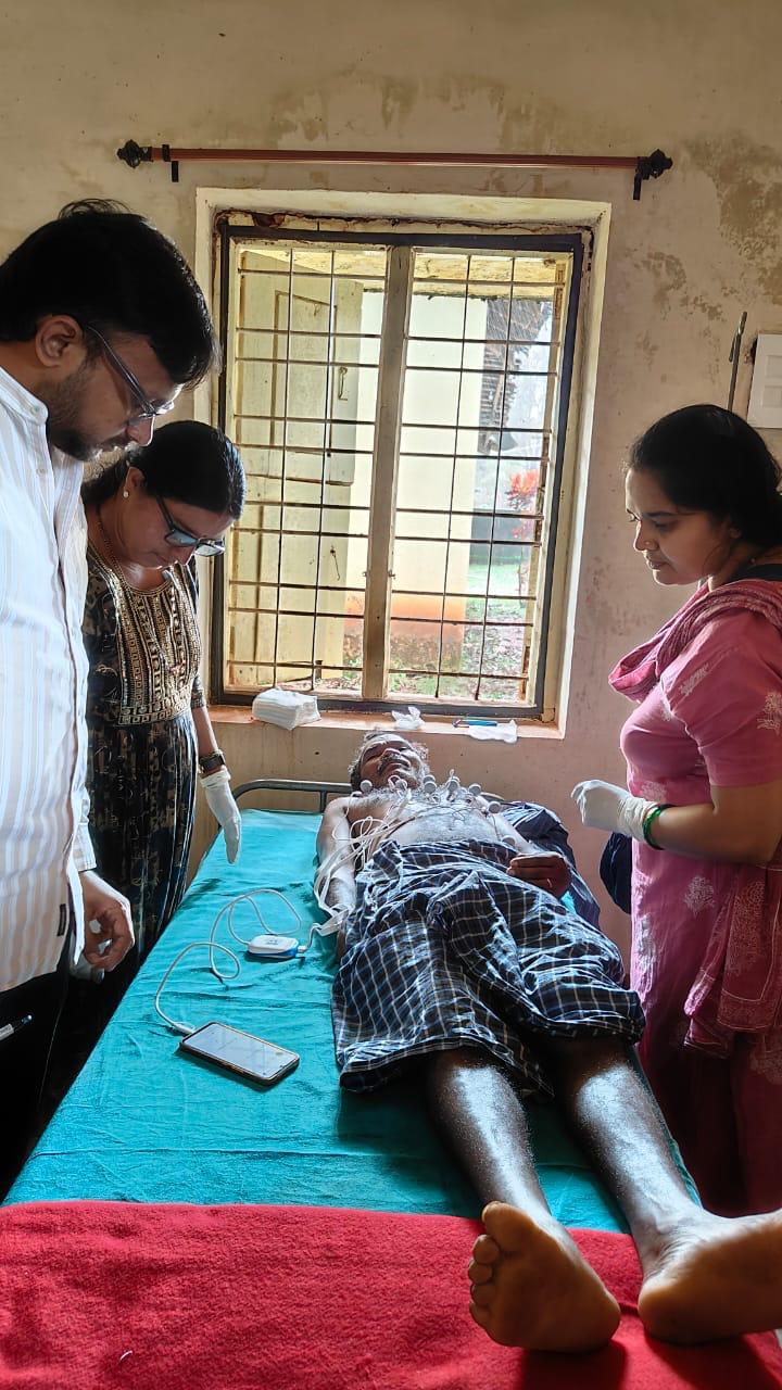 Health volunteers supporting cardiac screening in a rural clinic room